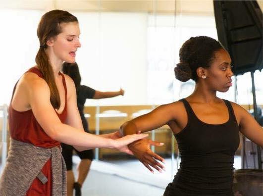 Dance 101 dance instructor helping a student in one of the studios